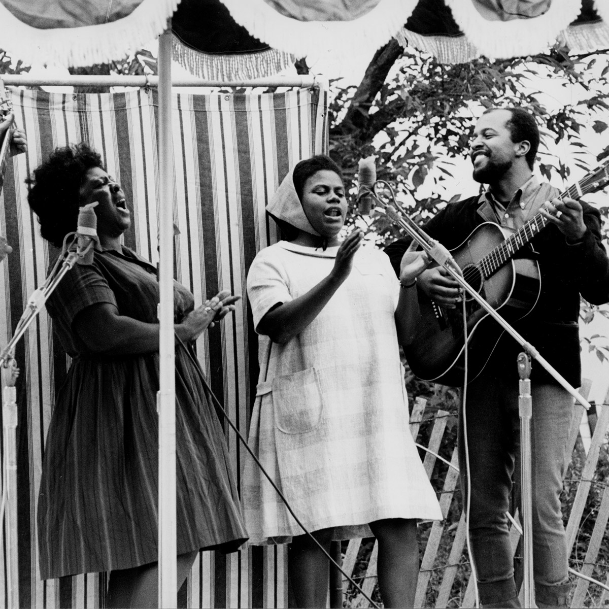 Guy Carawan, Fannie Lou Hamer, Bernice Johnson Reagon, and Len Chandler perform civil rights songs at the 1965 Newport Folk Festival. Photo by Diana Davies, Ralph Rinzler Folklife Archives